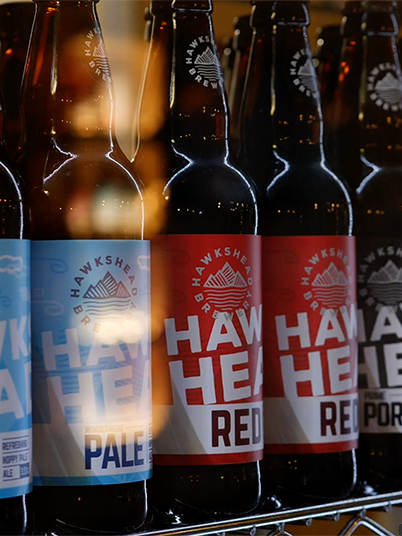 A range of Hakshead Brewery beers in a fridge. This is a still from a presenter-led brewery tour video filmed at Hawkshead Brewery in the Lake District.
