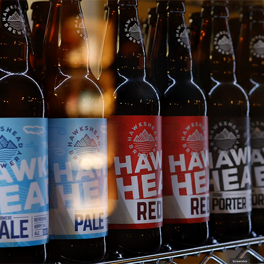 A range of Hakshead Brewery beers in a fridge. This is a still from a presenter-led brewery tour video filmed at Hawkshead Brewery in the Lake District.