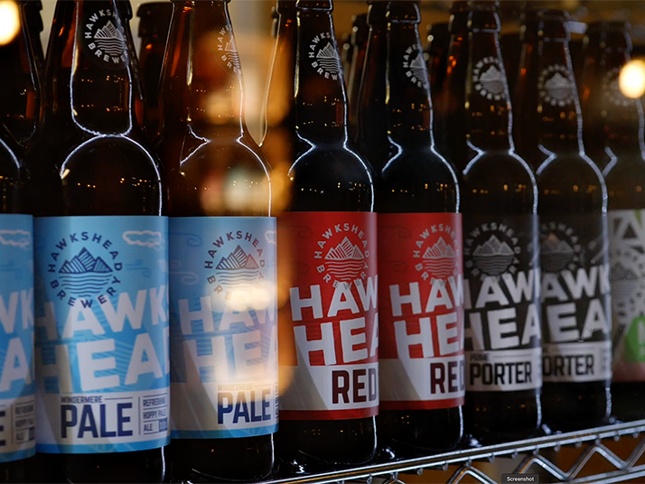 A range of Hakshead Brewery beers in a fridge. This is a still from a presenter-led brewery tour video filmed at Hawkshead Brewery in the Lake District.