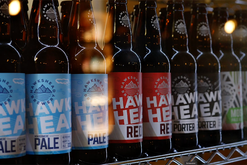 A range of Hakshead Brewery beers in a fridge. This is a still from a presenter-led brewery tour video filmed at Hawkshead Brewery in the Lake District.