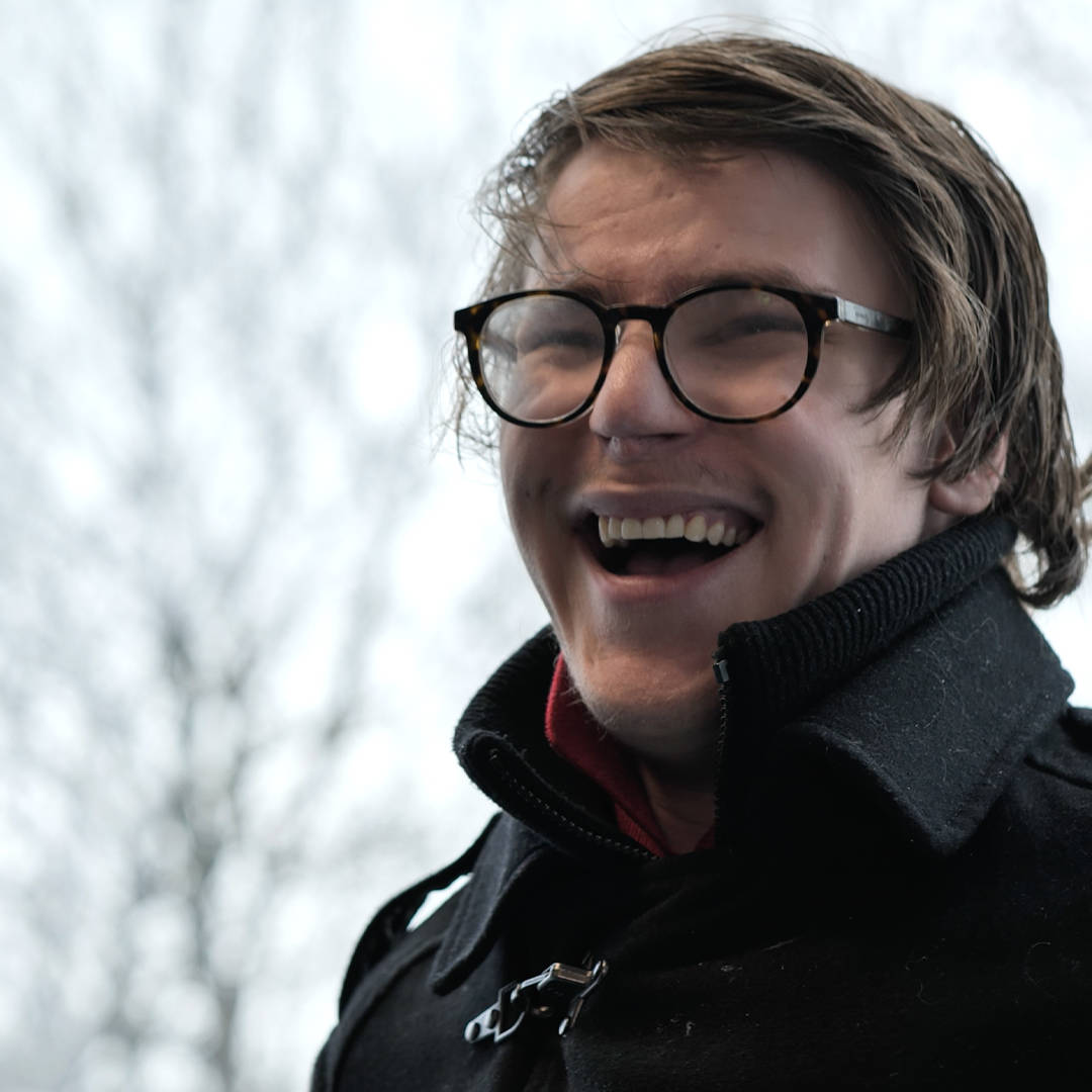 A student from Burlington House Sixth Form smiling during his interview for the documentary style video