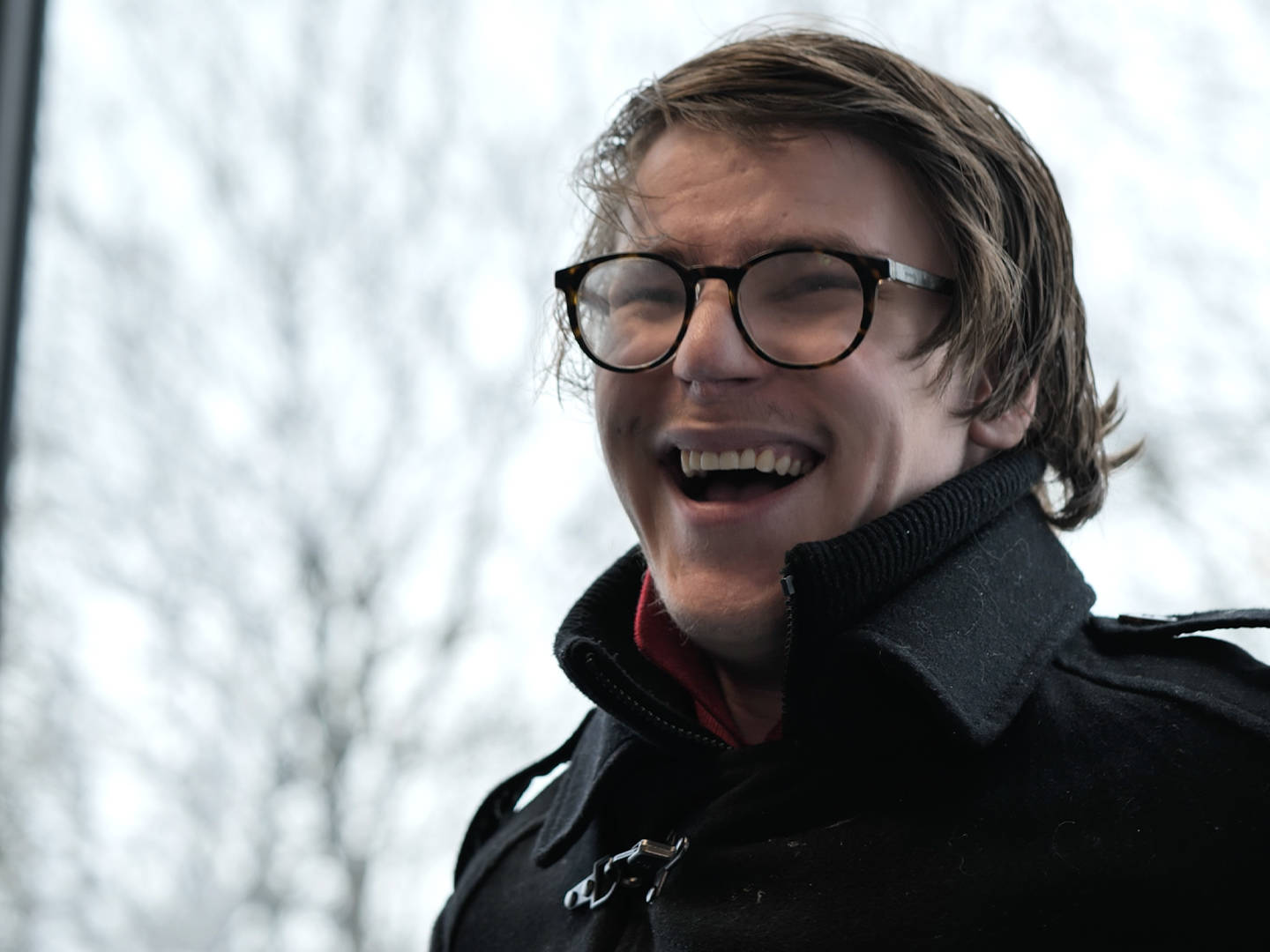 A student from Burlington House Sixth Form smiling during his interview for the documentary style video