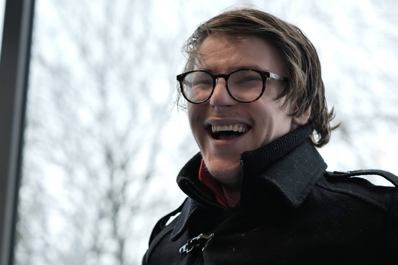 A student from Burlington House Sixth Form smiling during his interview for the documentary style video