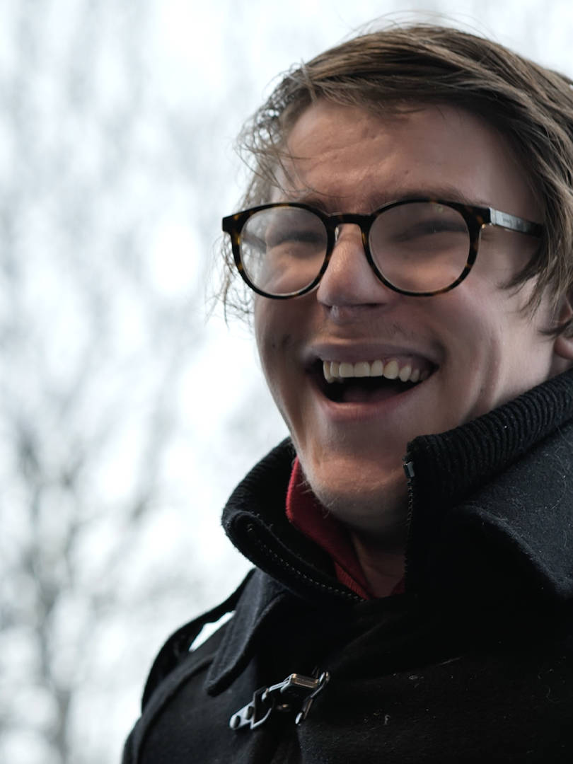 A student from Burlington House Sixth Form smiling during his interview for the documentary style video