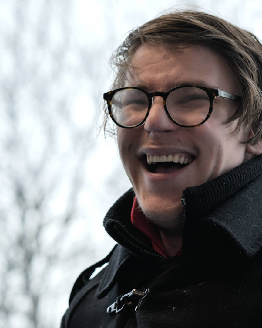A student from Burlington House Sixth Form smiling during his interview for the documentary style video