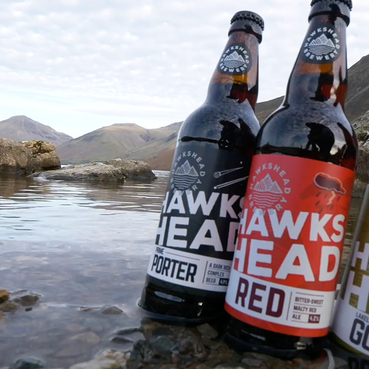 A selection of Hawkshead Brewery products sit on the edge of Wast Water Lake in the Lake District.