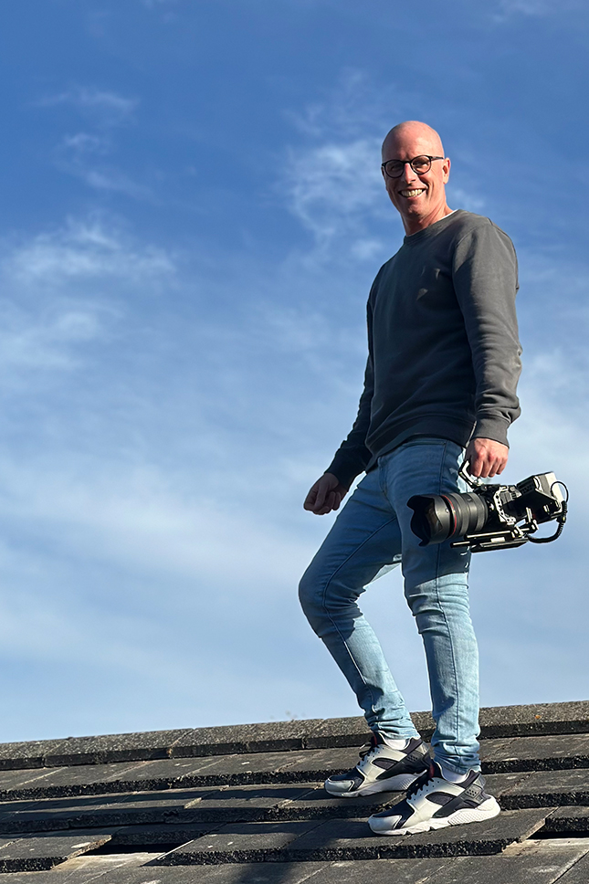 A photo of Matt Bell carrying a camera on a gimbal for a corporate video production in Liverpool.