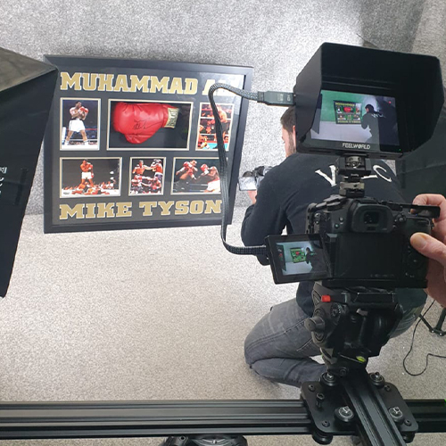 Team member handling luxury auction items during a professional content creation shoot