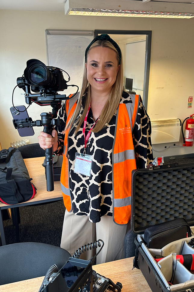 A photo of Rachel Airey carrying a camera on a gimbal for a corporate video production in Manchester.