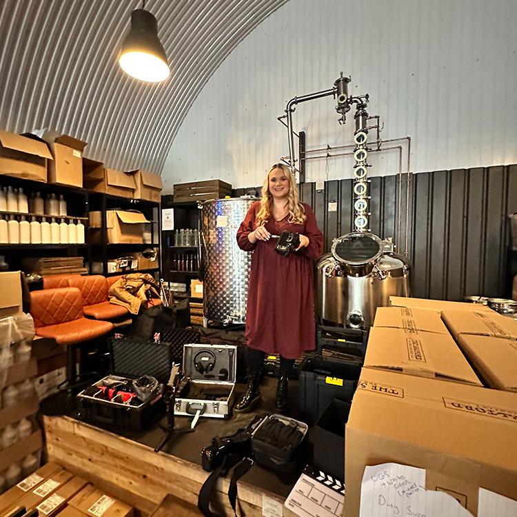 Videographer Rachel Airey sets up the video equipment at a video shoot at a brewery in Manchester.