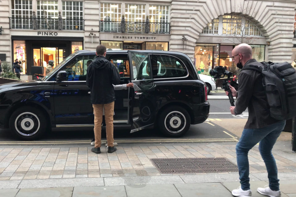 Matt Bell films Callum Russell getting into a black cab on Regent Street in London for a video highlighting Regent Street accessibility.