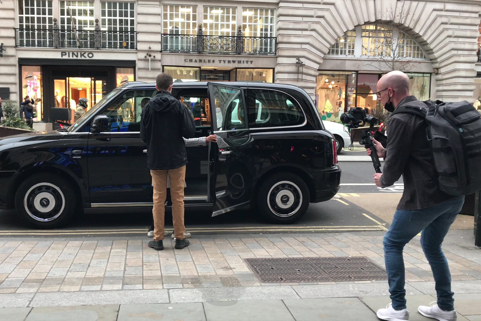 Matt Bell films Callum Russell getting into a black cab on Regent Street in London for a video highlighting Regent Street accessibility.