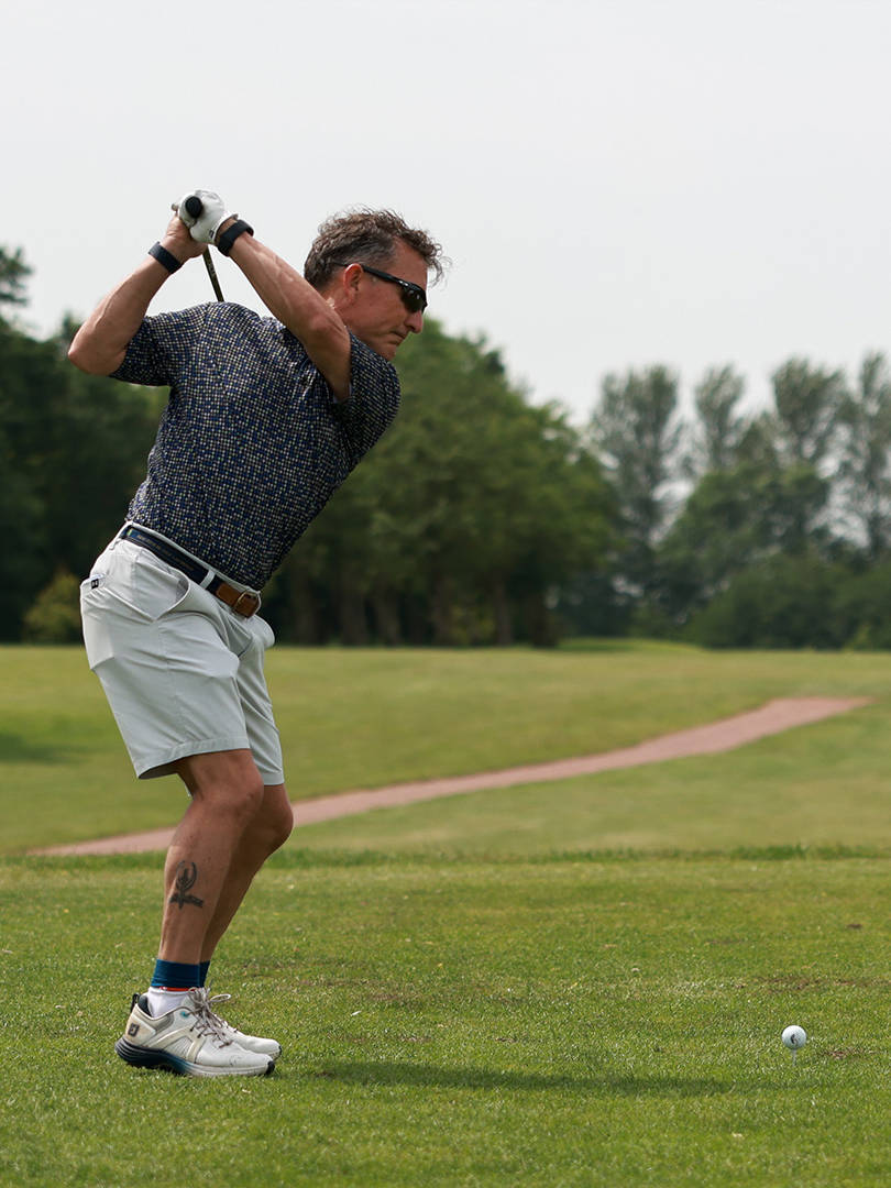 A golfer tees off at Hurlston Hall Golf and Country Club