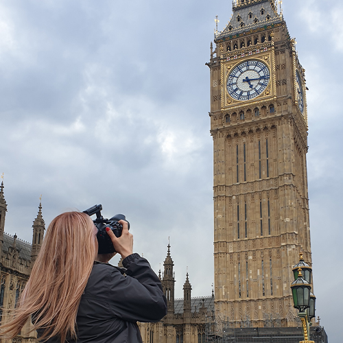 A photographer taking photos of Big Ben in London