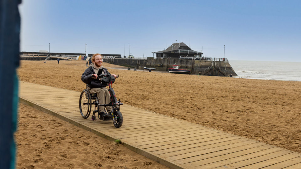 Charlie Randall travels along an accessible walkway on the beach in Margate, Ramsgate and Broadstairs. Photographer is Rachel Airey from Surfr Media.