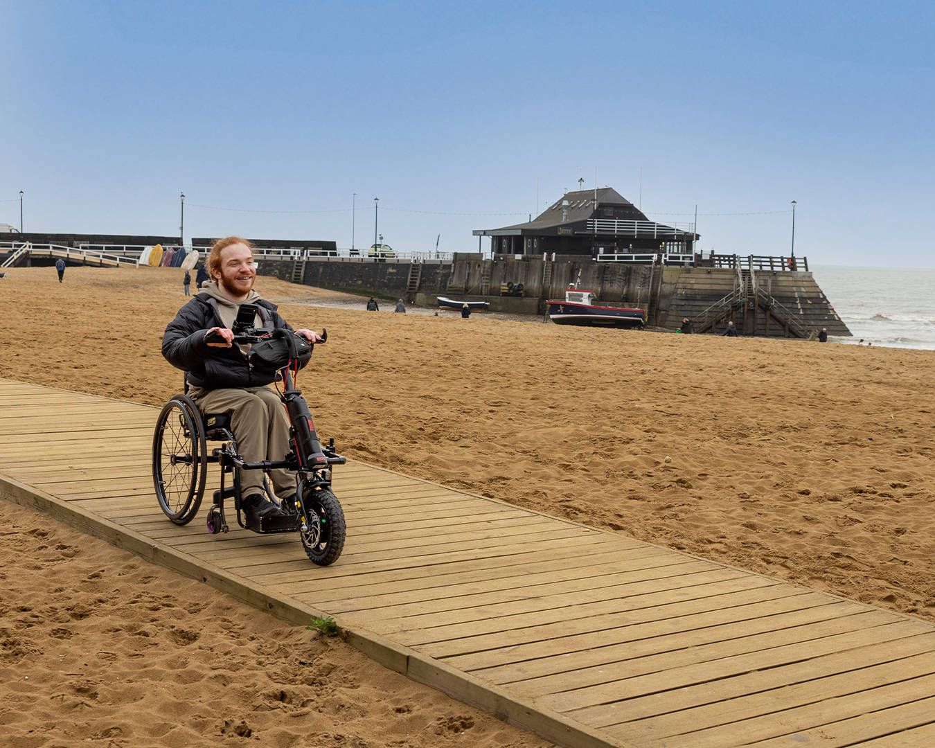 Charlie Randall travels along an accessible walkway on the beach in Margate, Ramsgate and Broadstairs. Photographer is Rachel Airey from Surfr Media.