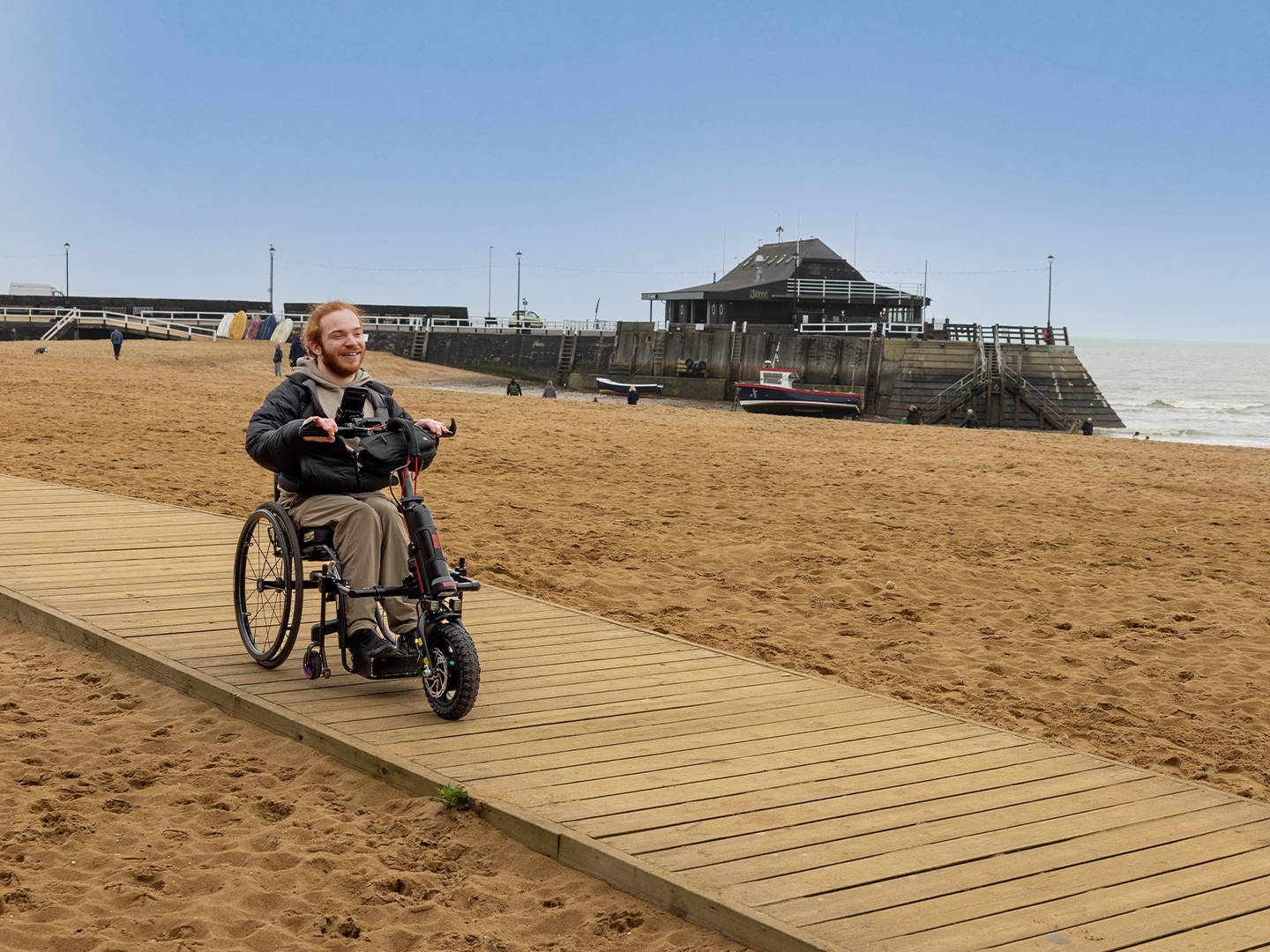 Charlie Randall travels along an accessible walkway on the beach in Margate, Ramsgate and Broadstairs. Photographer is Rachel Airey from Surfr Media.
