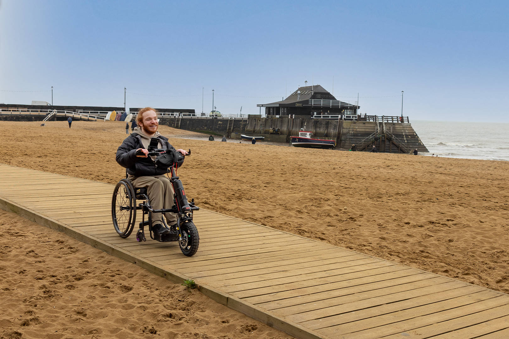 Charlie Randall travels along an accessible walkway on the beach in Margate, Ramsgate and Broadstairs. Photographer is Rachel Airey from Surfr Media.