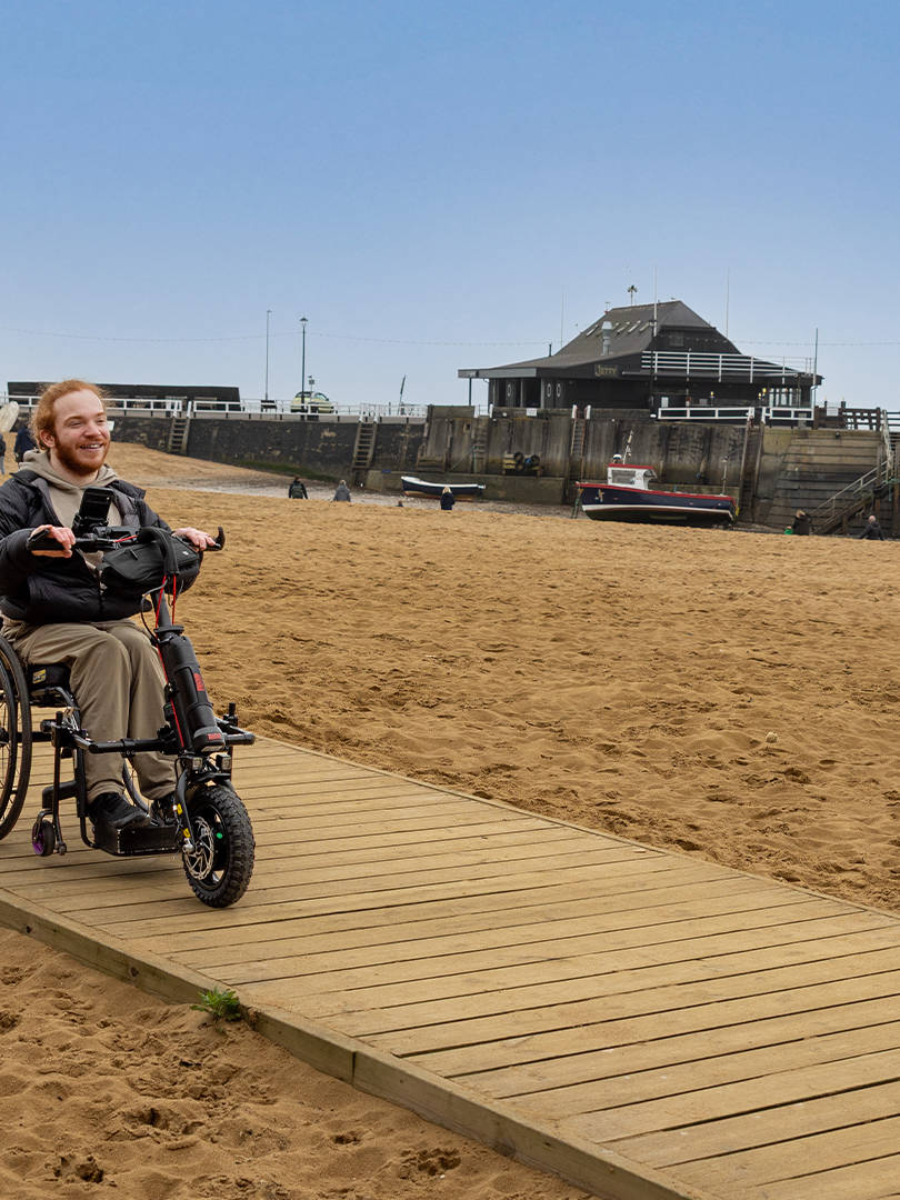 Charlie Randall travels along an accessible walkway on the beach in Margate, Ramsgate and Broadstairs. Photographer is Rachel Airey from Surfr Media.