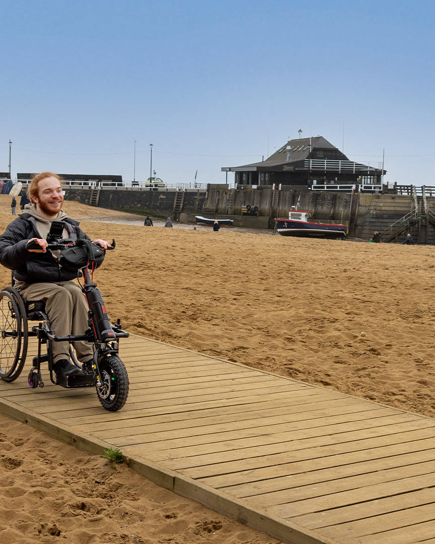 Charlie Randall travels along an accessible walkway on the beach in Margate, Ramsgate and Broadstairs. Photographer is Rachel Airey from Surfr Media.