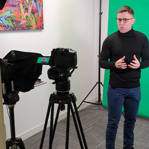 A host presents to the camera during filming for a series of videos for an App in Liverpool